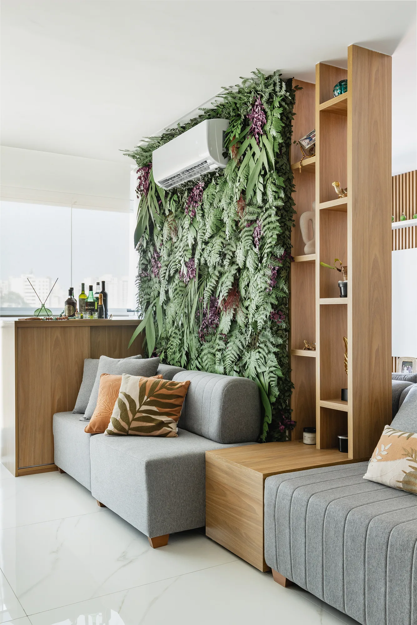 Jardim vertical com estante de madeira ao lado do sofá cinza